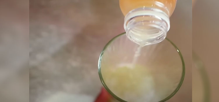 Pouring Apple Cider Vinegar on a Glass