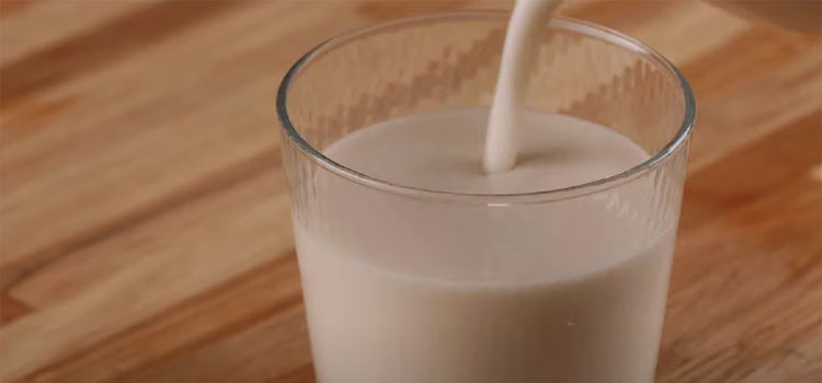 Pouring oatmilk on a glass