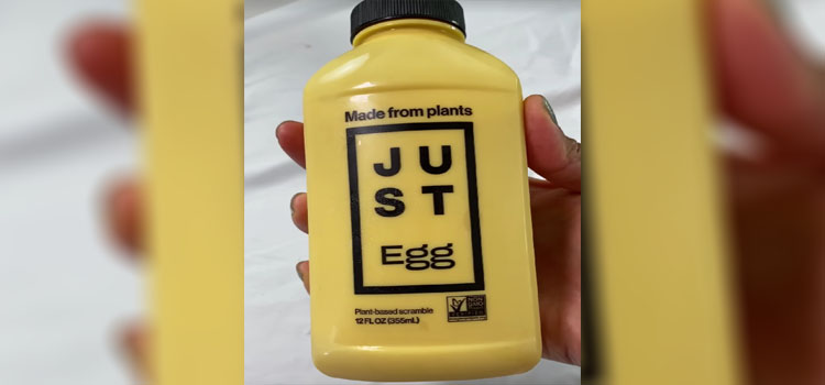 Hand Holding Bottle of Just Egg