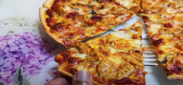 Person Getting a Slice of Curry Pizza