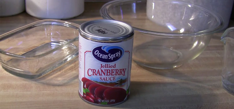 Canned Cranberry Sauce with Glass Containers on a Wooden Table