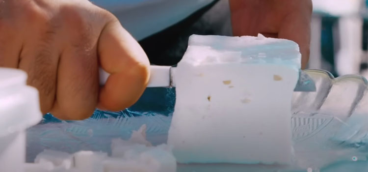 Person Slicing Feta Cheese