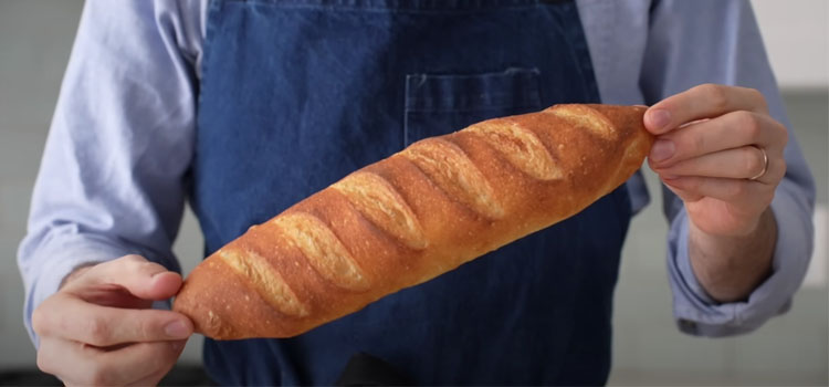 Man Holding Baguette Bread