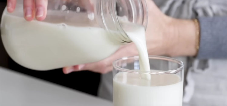 Pouring Oat Milk on a Glass