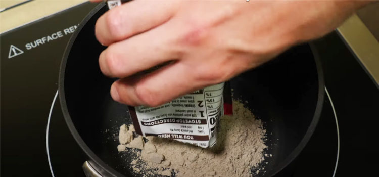 Pouring Brown Gravy Mix Powder on a Pot