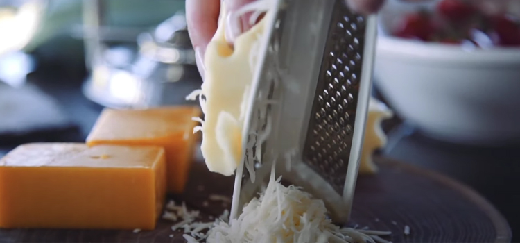 Woman Grating a Cheese