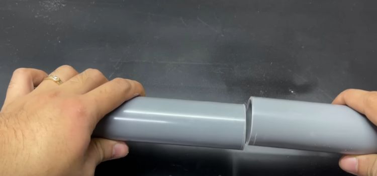 Hand Holding PVC Pipes